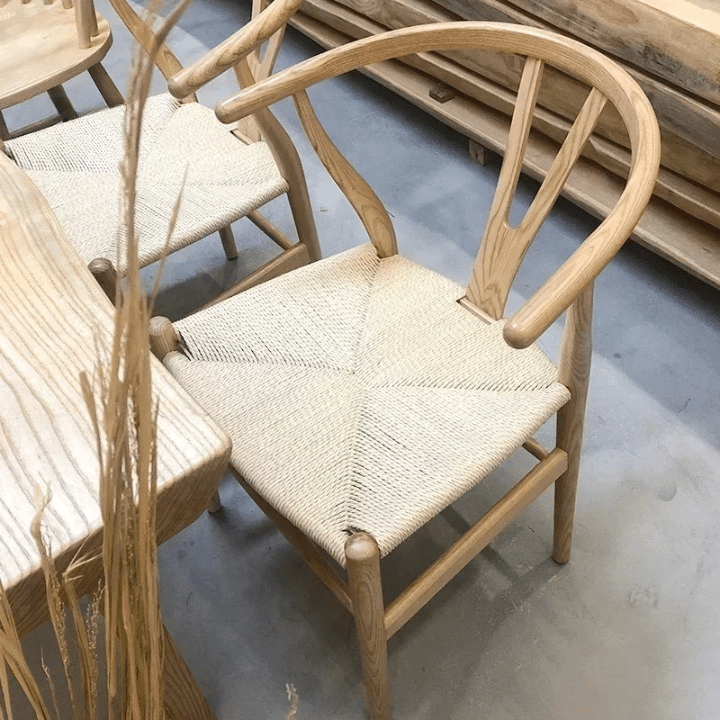 Nordic solid wood chair with a wicker-look weave – shown in a room setting