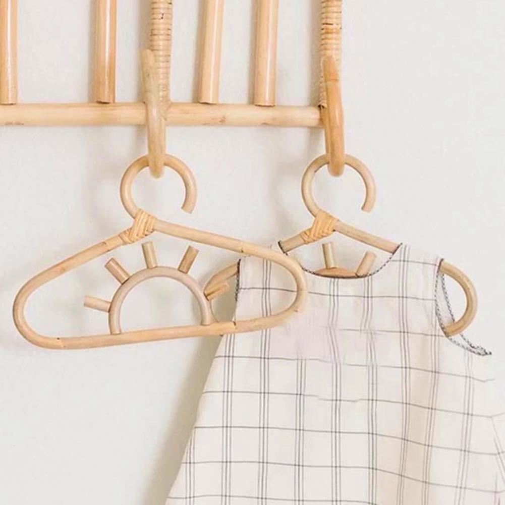 Sun-shaped rattan kids hanger – shown in a room setting