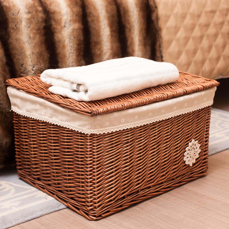 Lined rattan toy basket with lace trim – shown in a room setting (2)