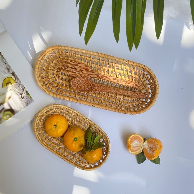 Set of two handwoven rattan catchall baskets – shown in a room setting