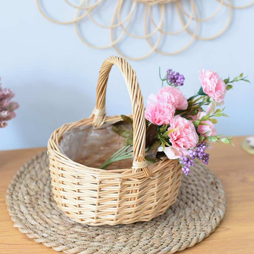 Beige round handwoven rattan basket with a sturdy handle – shown in a room setting (3)