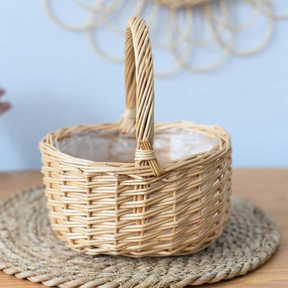 Beige round handwoven rattan basket with a sturdy handle