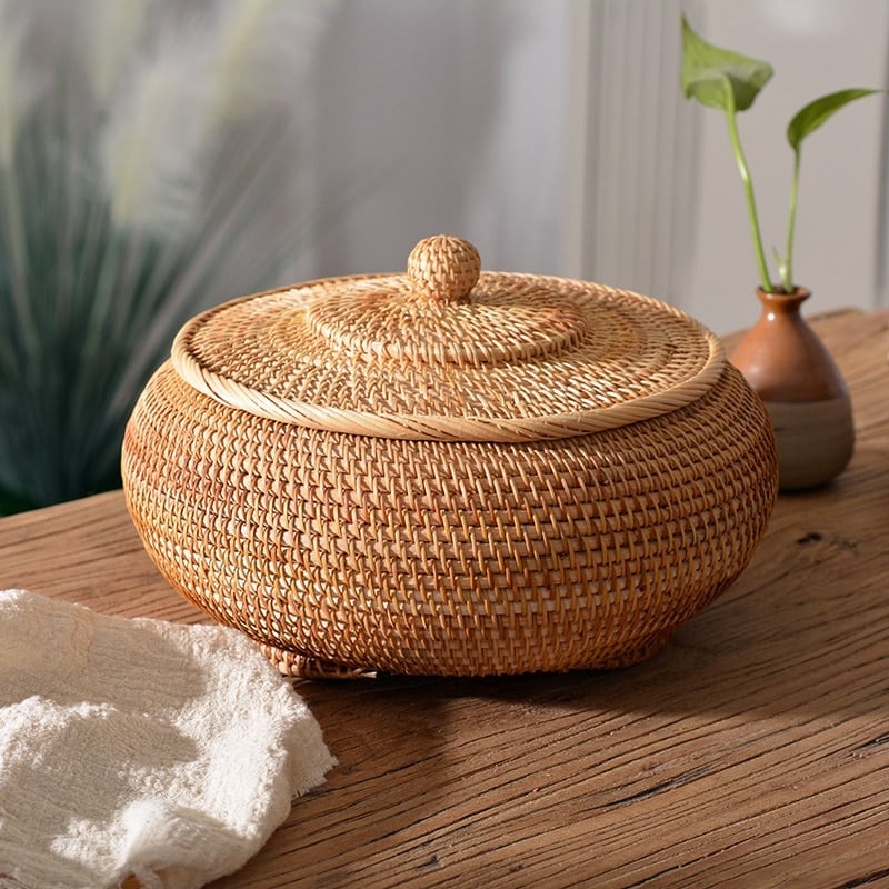 Round handwoven rattan basket with a fitted lid – shown in a room setting (2)