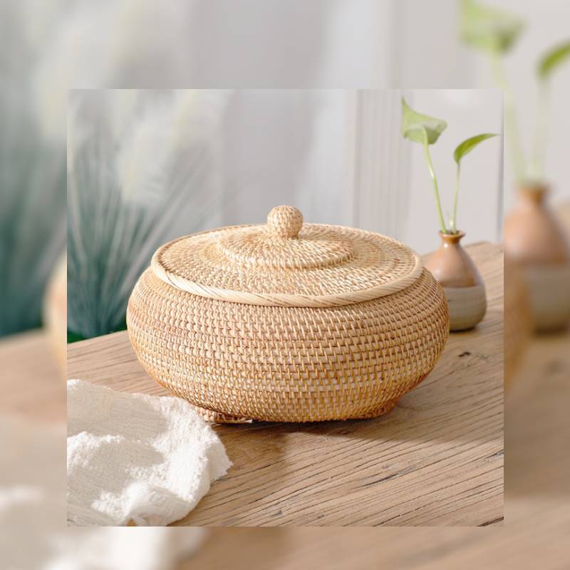 Round handwoven rattan basket with a fitted lid – shown in a room setting (3)