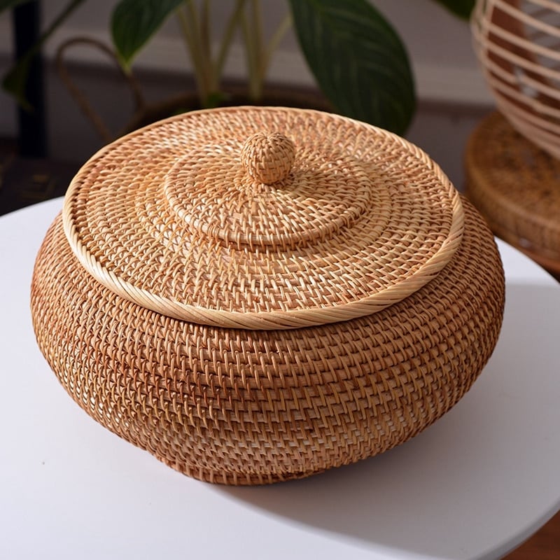 Round handwoven rattan basket with a fitted lid – shown in a room setting