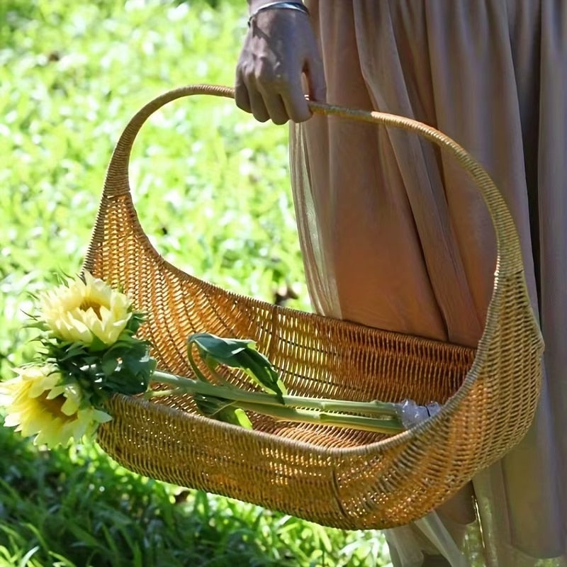 Rustic open-weave rattan basket with a sturdy handle – shown in use