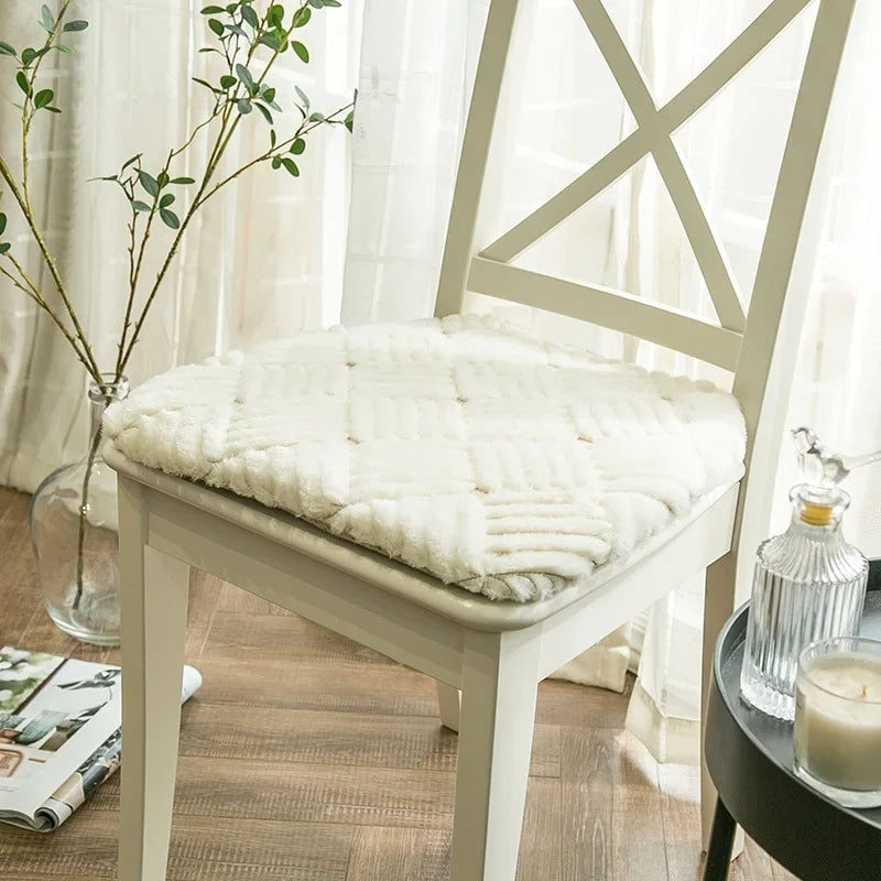 Thick round plush chair cushion with a rattan-look weave – white variant, shown in a room setting