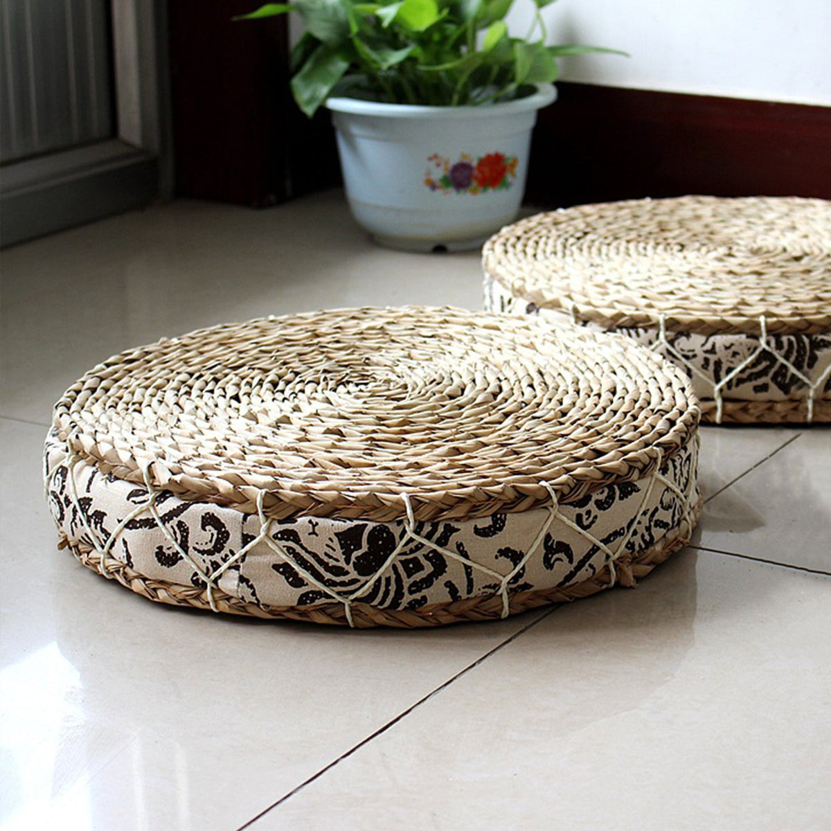 Round cushion with a rattan center and black-and-white fabric border – shown in a room setting