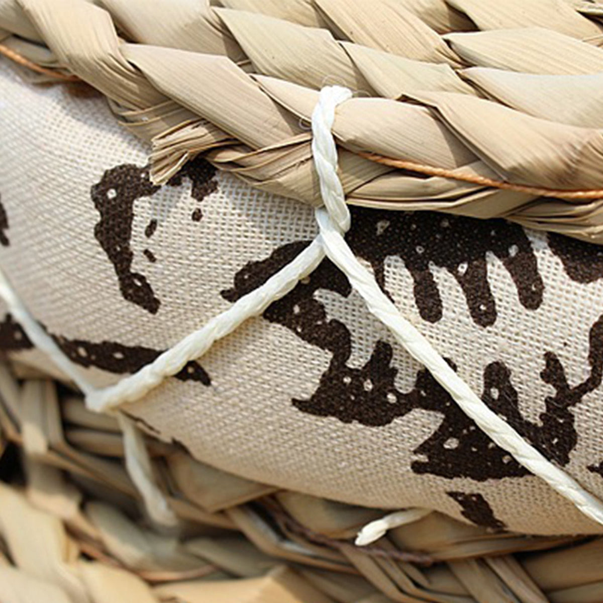 Round cushion with a rattan center and black-and-white fabric border – close-up detail