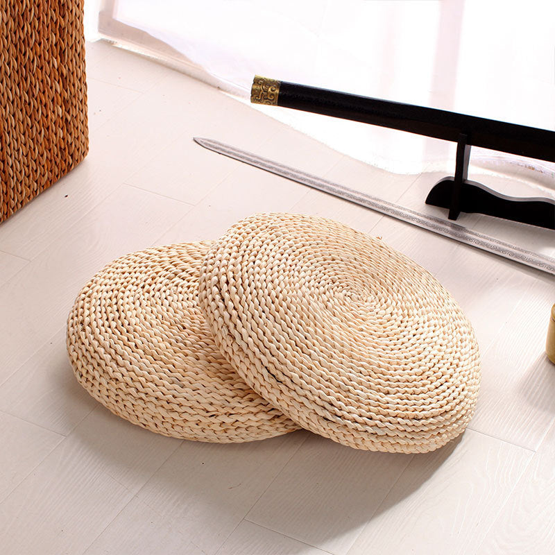 Round light woven rattan cushion – shown in a room setting