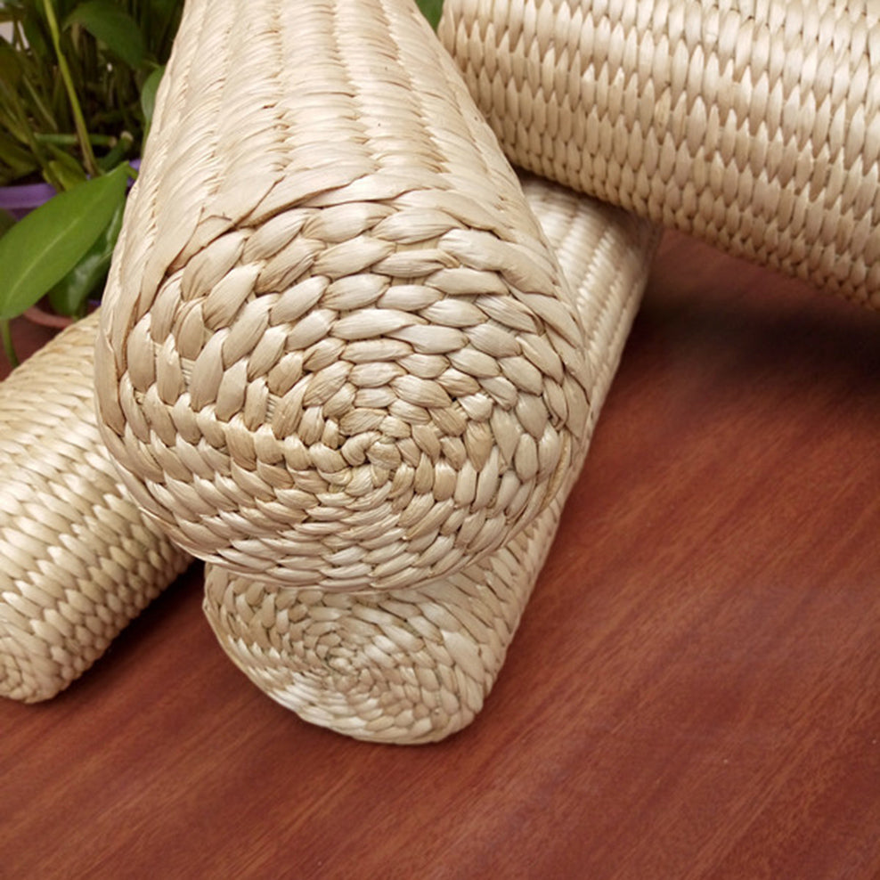 Cylindrical light rattan bolster pillow – close-up detail