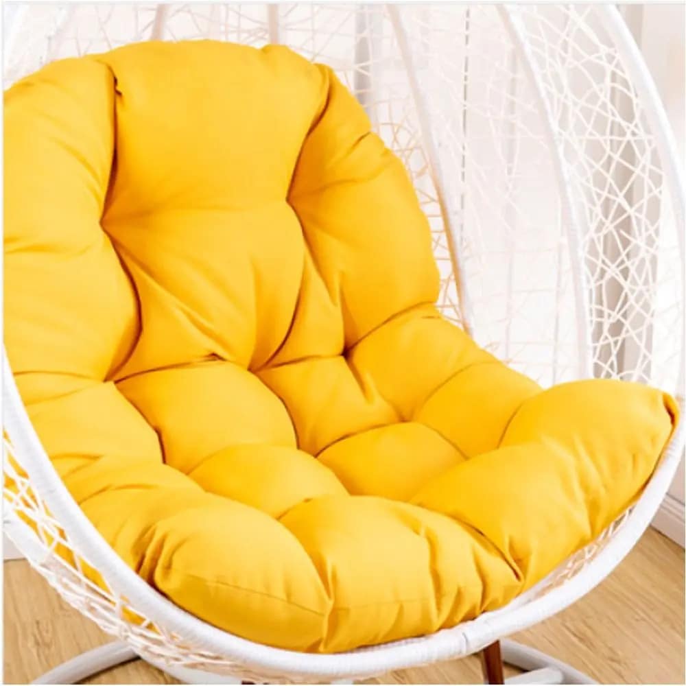 Spacious padded cushion for a rattan loveseat chair – yellow variant, shown in a room setting