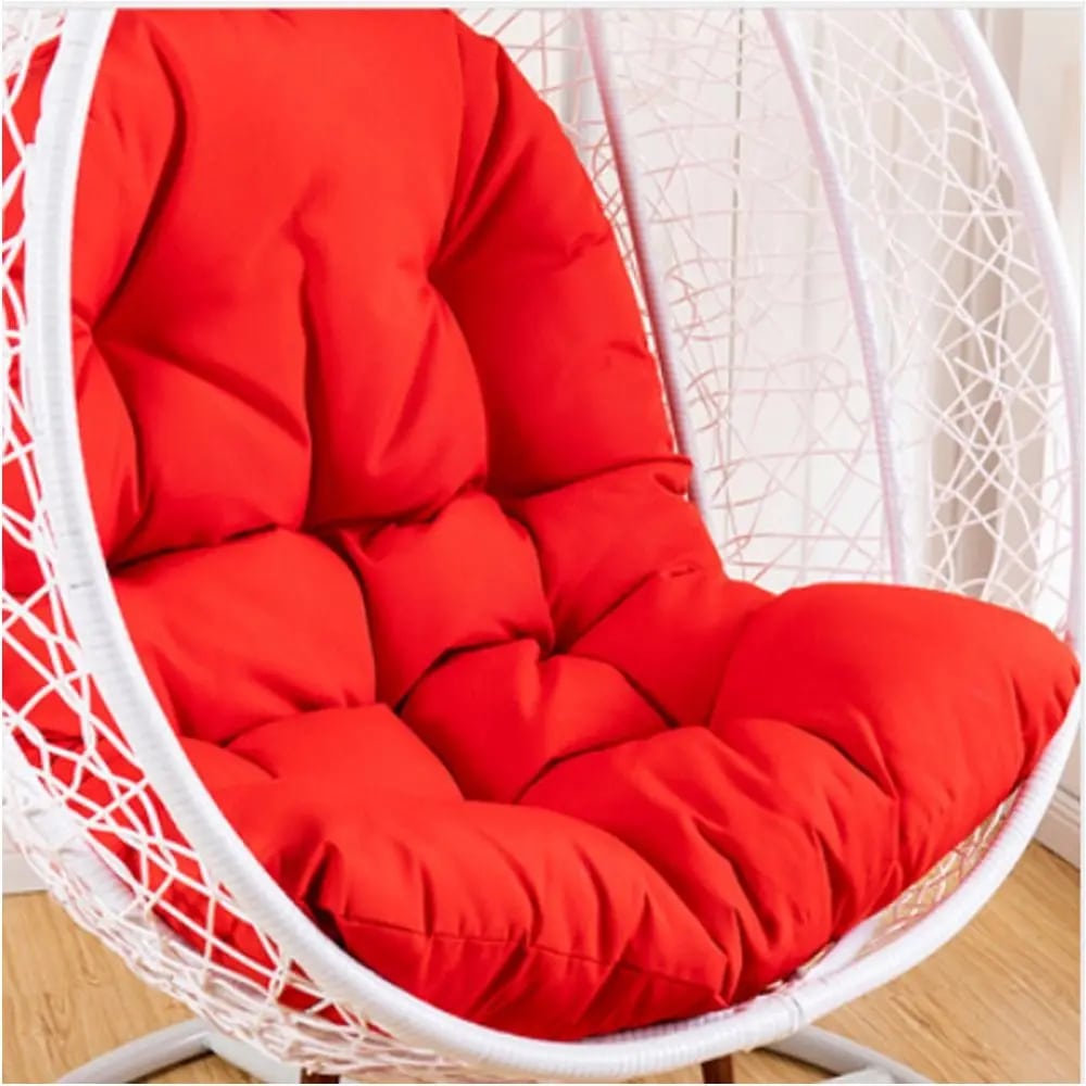 Spacious padded cushion for a rattan loveseat chair – red variant, shown in a room setting