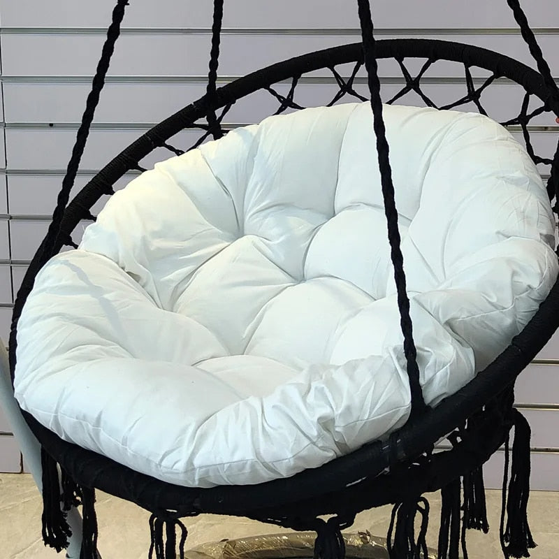 Modern round cotton-filled cushion for a rattan loveseat – shown in a room setting (2)