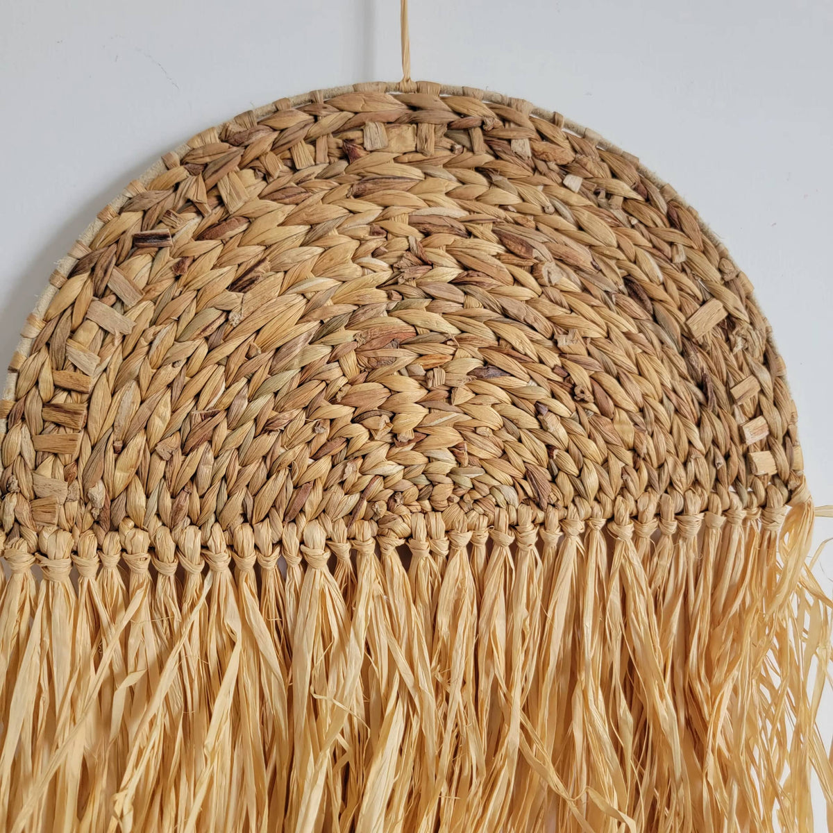 Free-form honey rattan wall art with irregular curves – close-up detail