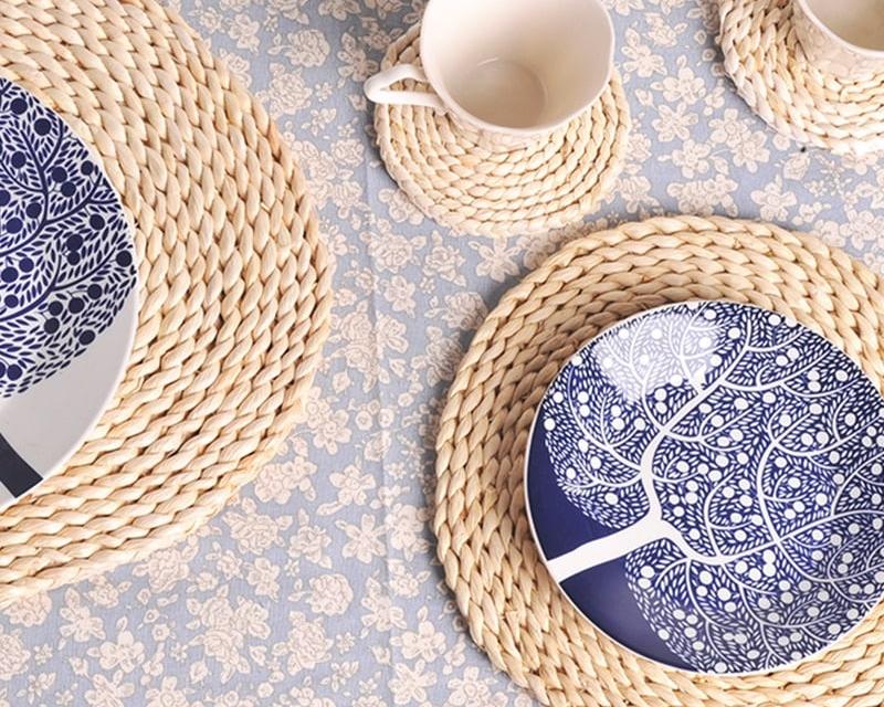 Round woven natural rattan trivet – shown in a room setting (2)