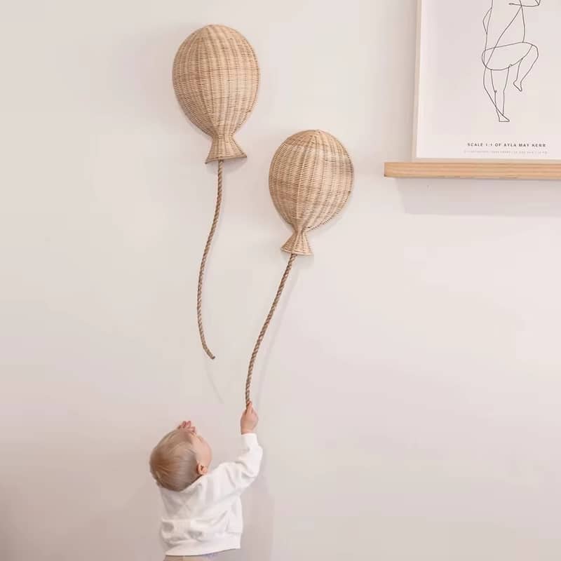 Set of two hand-braided rattan balloon wall decorations – shown in use