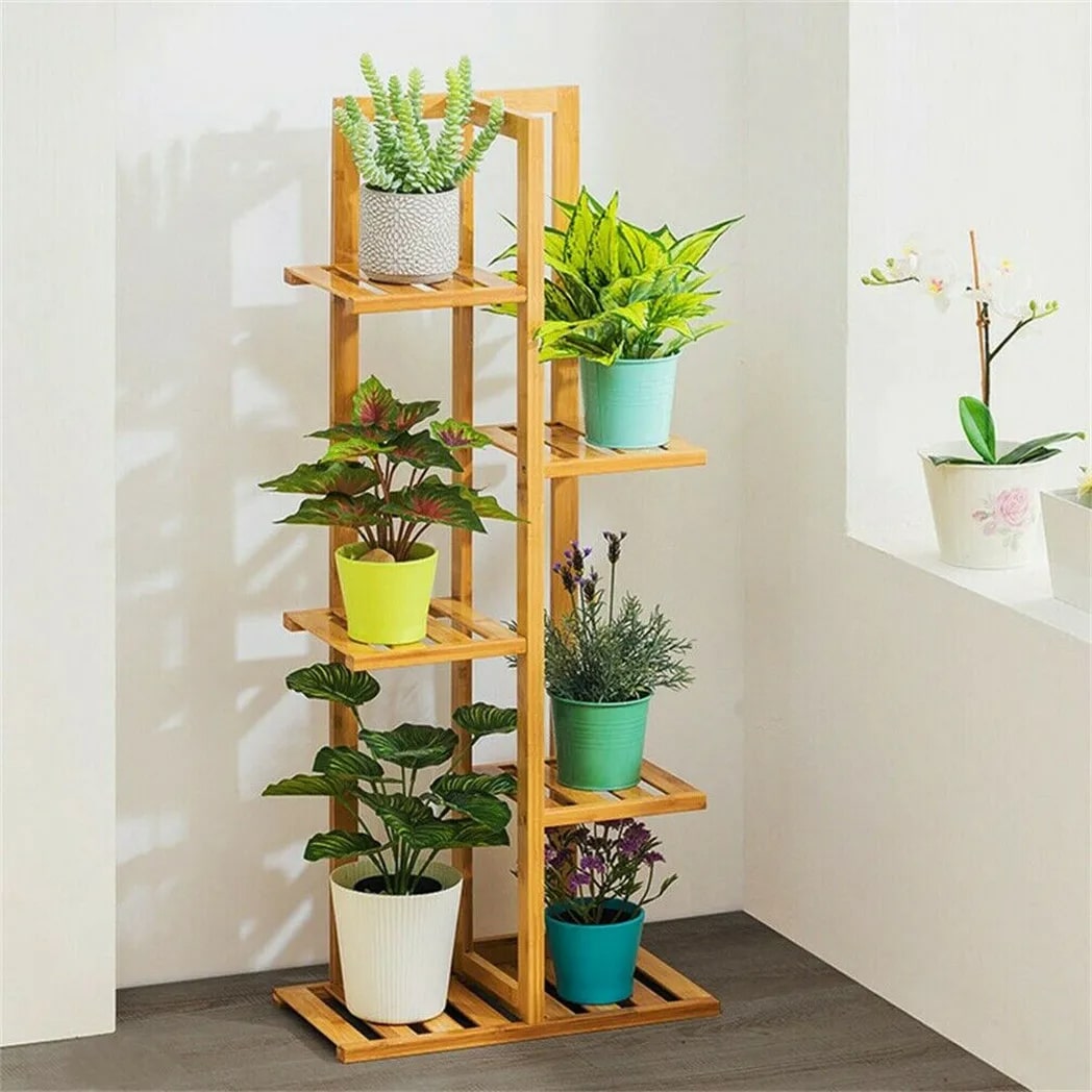 Five-tier bamboo plant stand displaying plants at different heights – shown in a room setting