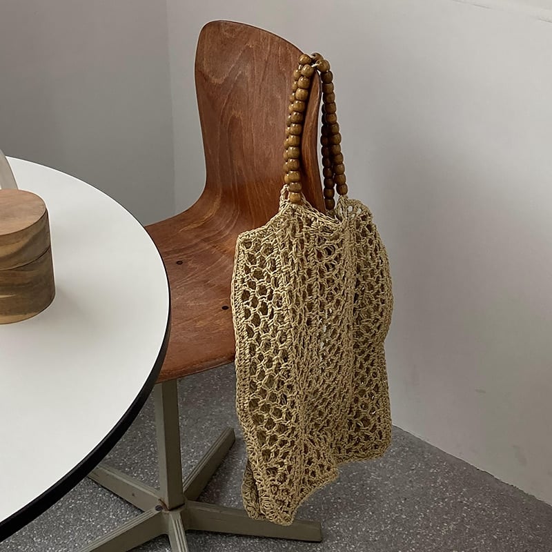 Large handwoven natural straw summer tote – shown in a room setting (2)