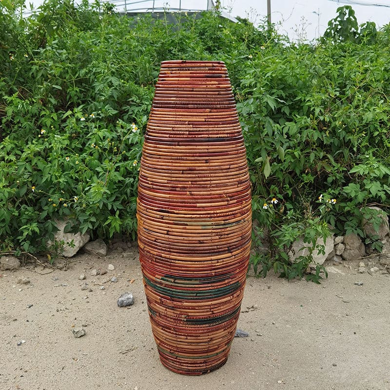 Large dark natural bamboo vase with a generous curve – shown outdoors