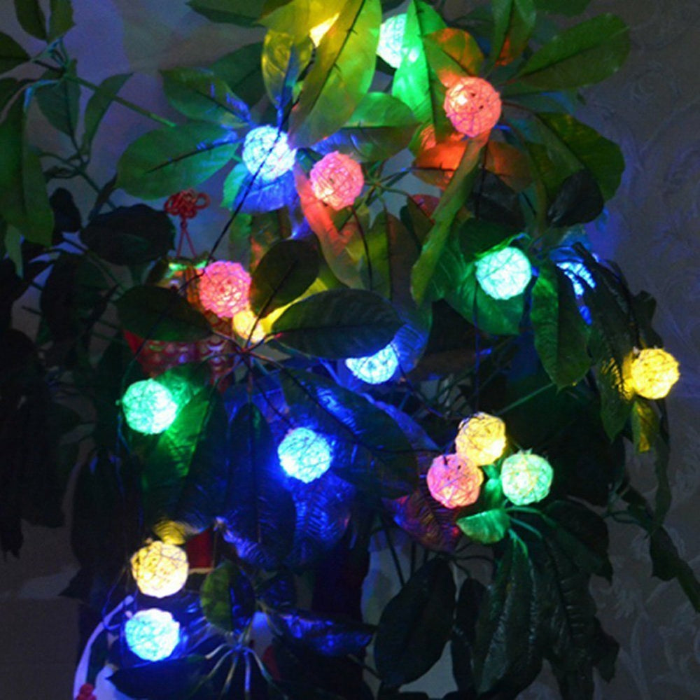 Rattan Christmas string lights with miniature woven shades – shown lit in a room setting (2)