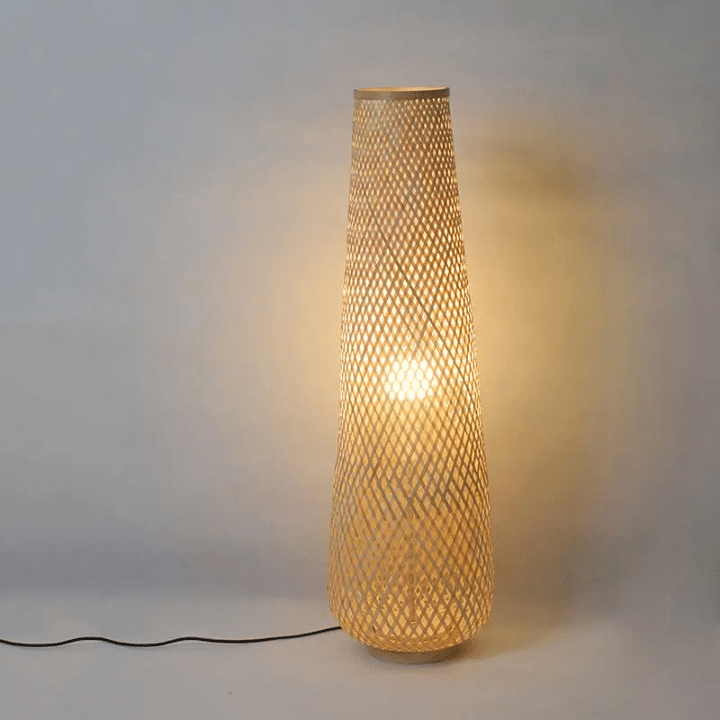 Nordic wicker-look floor lamp with a woven shade and slim metal stem – shown lit