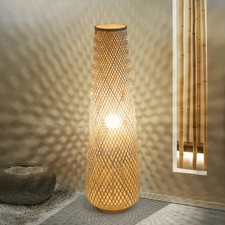 Nordic wicker-look floor lamp with a woven shade and slim metal stem – close-up detail, lit