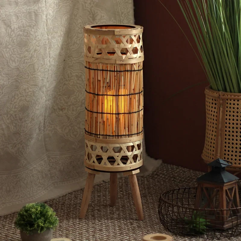 Wicker-look floor lamp with an electric candle – shown lit in a room setting