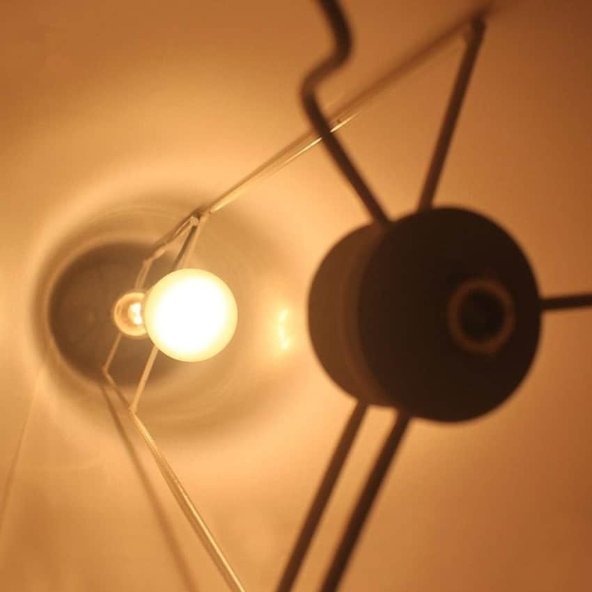Handwoven rattan mushroom floor lamp with a rounded cap – close-up detail, lit