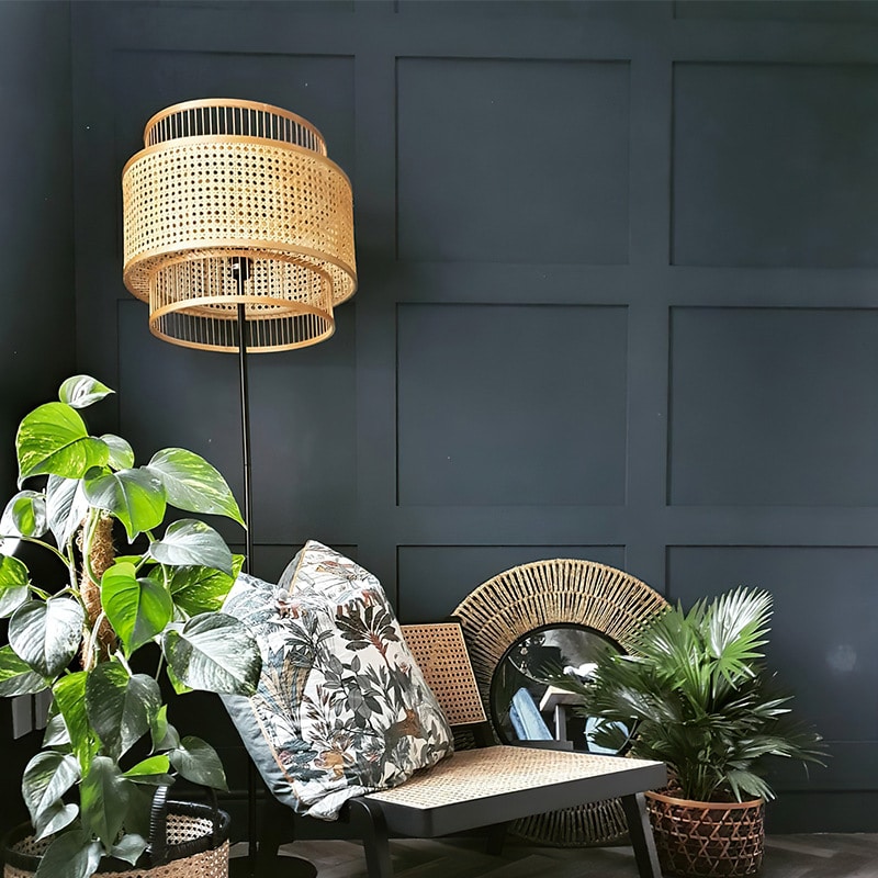 Double-shade rattan and bamboo floor lamp – shown in a room setting