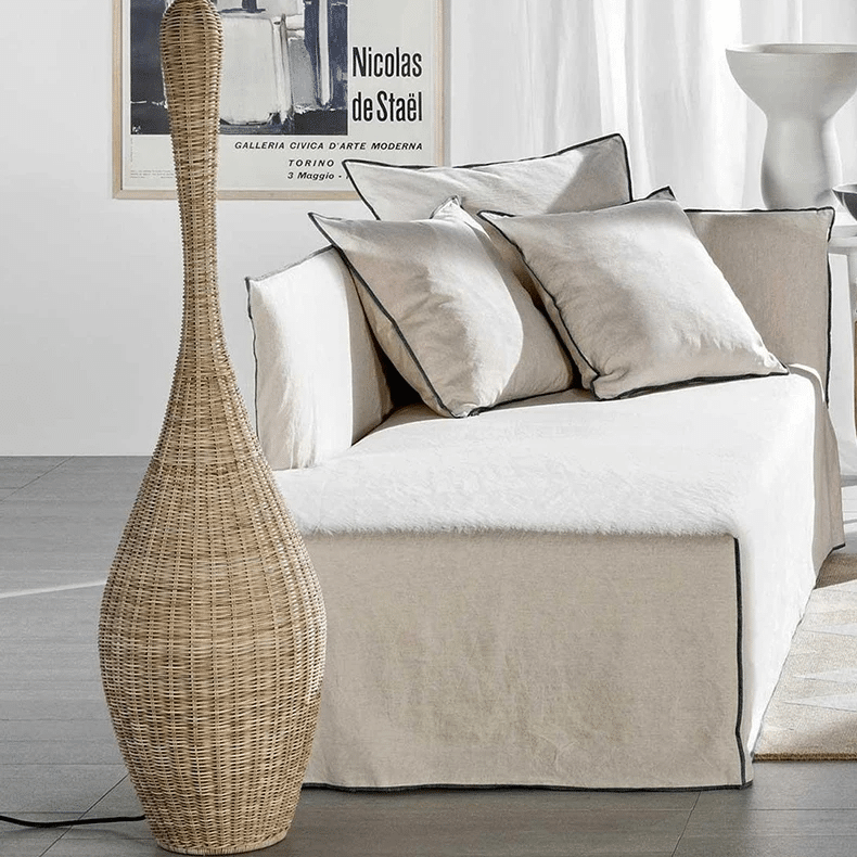 Japanese-style free-standing wicker LED floor lamp with a natural wood base – shown in a room setting