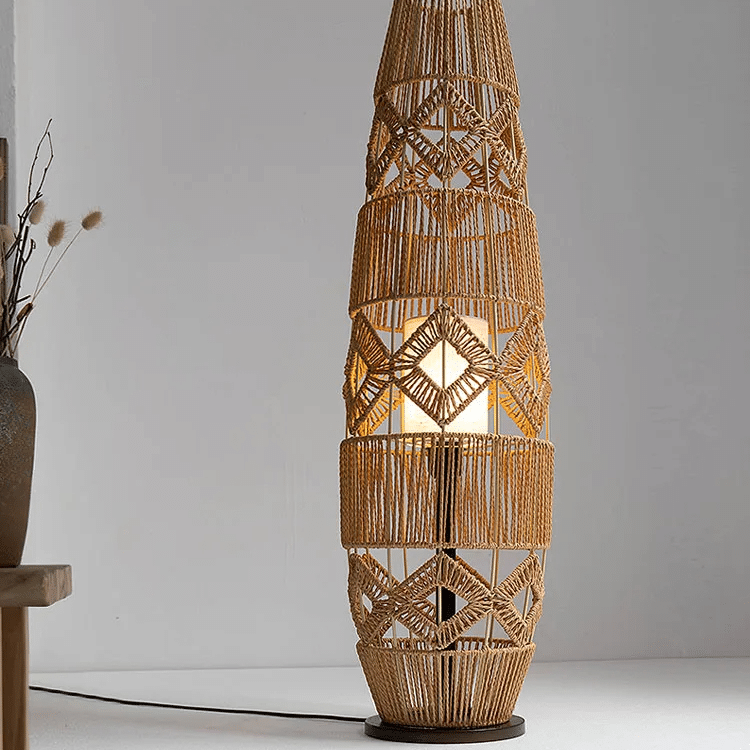 Hand-knit wicker LED floor lamp with a tightly woven shade – shown lit