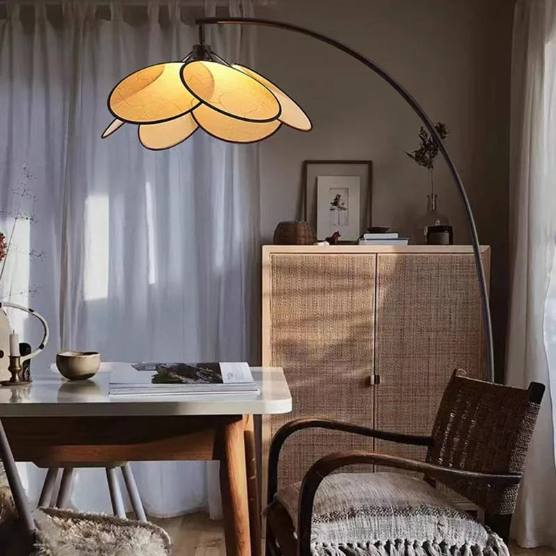 Rattan petal LED floor lamp with petals arranged in a crown – shown in a room setting (2)