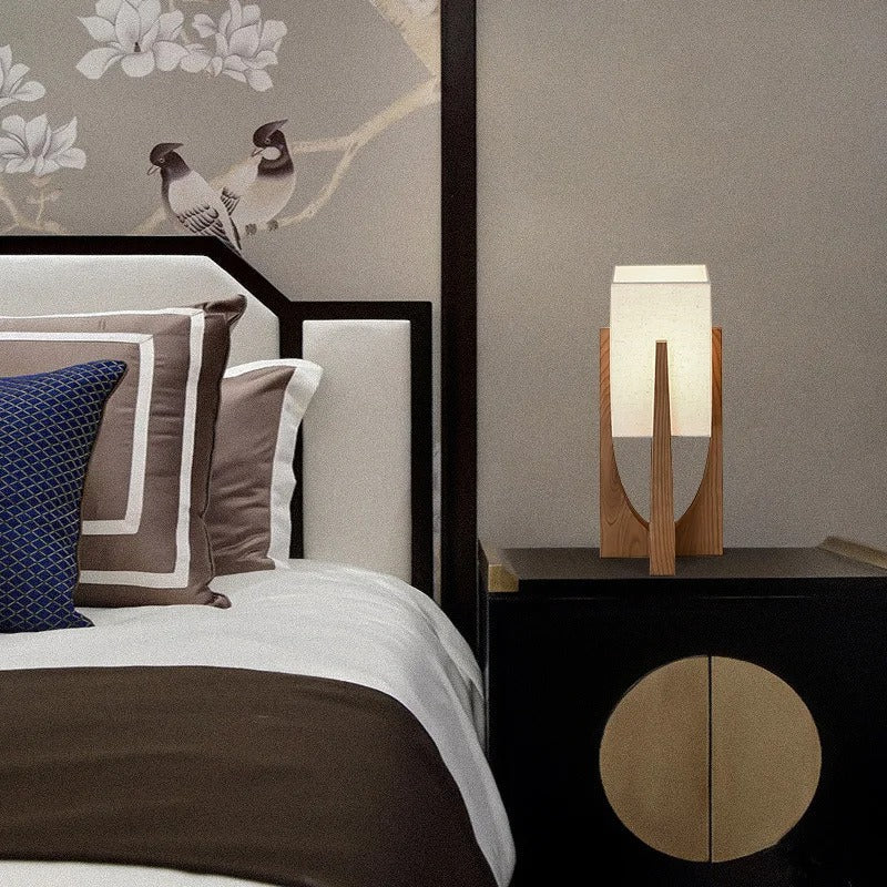 Modern wood table lamp with a handwoven shade – shown in a room setting (3)