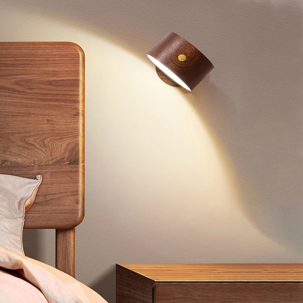 Wood swing-arm bedside wall lamp – shown lit in a room setting