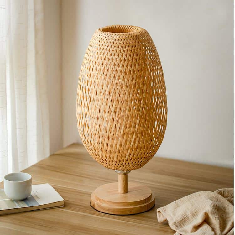 Oval rattan table lamp on a turned wood base