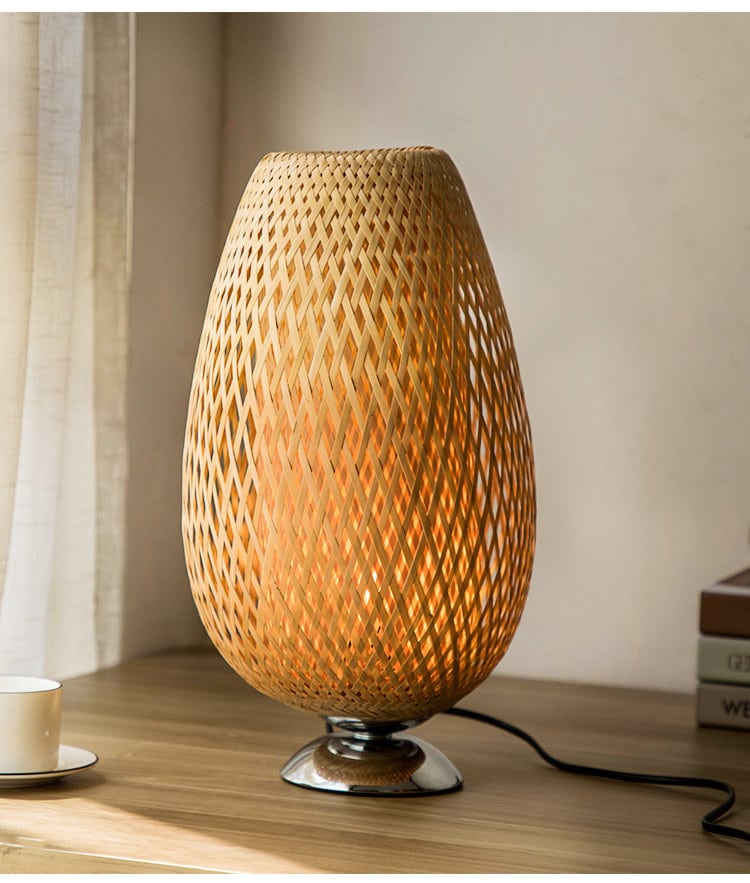 Oval handwoven rattan bedside lamp on a metal base