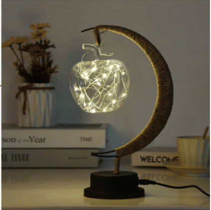 USB woven hemp crescent moon lamp with an apple-shaped bulb – shown lit