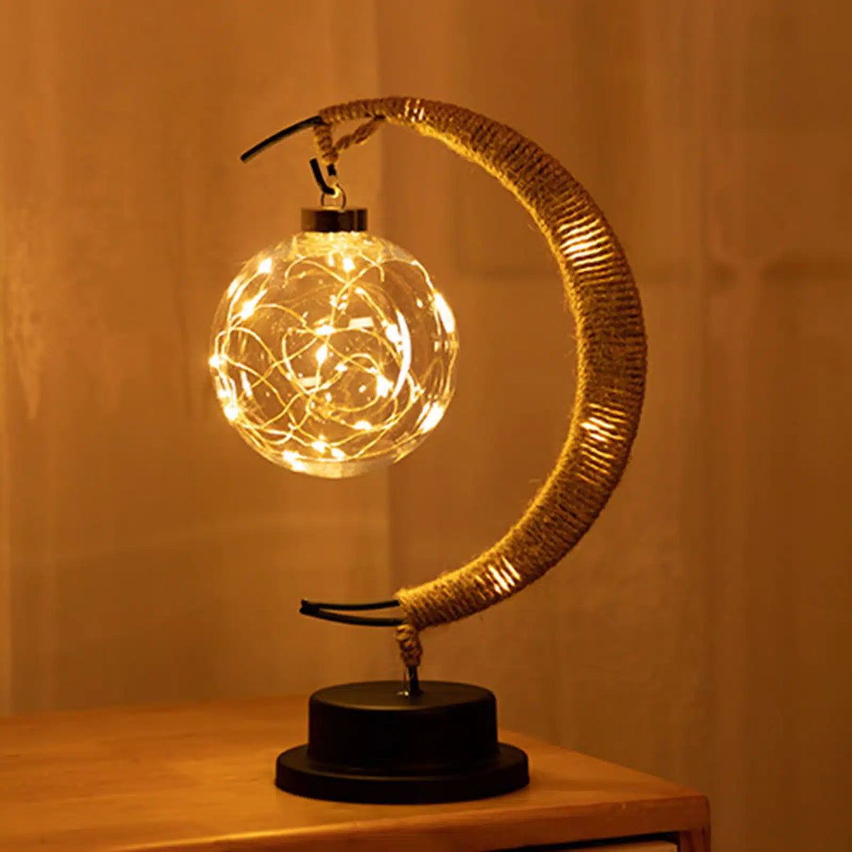 USB woven hemp crescent moon lamp in gold tones – shown lit
