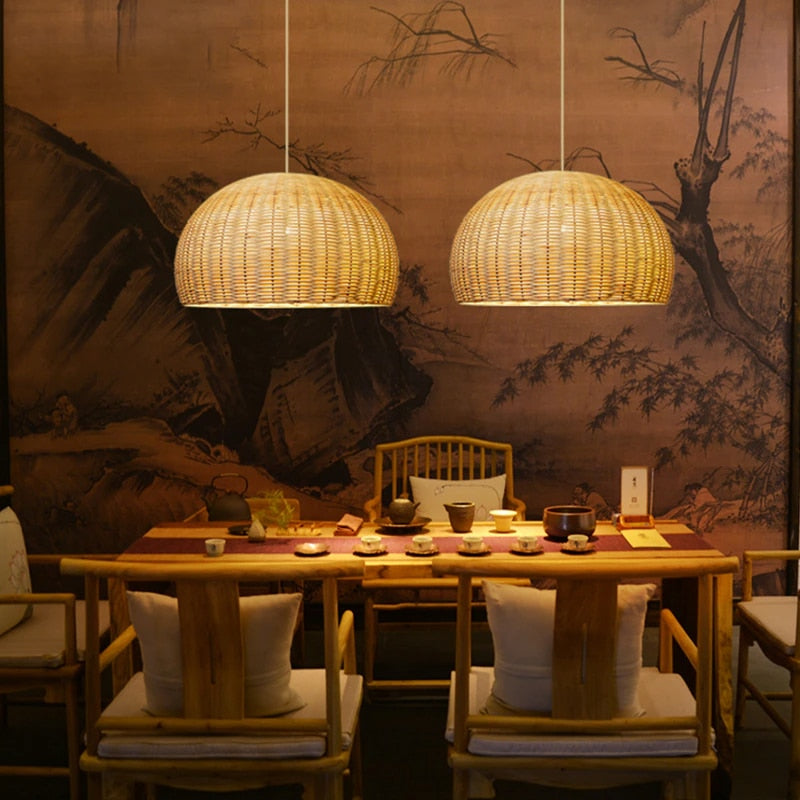 Rustic round handwoven rattan pendant light – shown lit in a room setting (2)