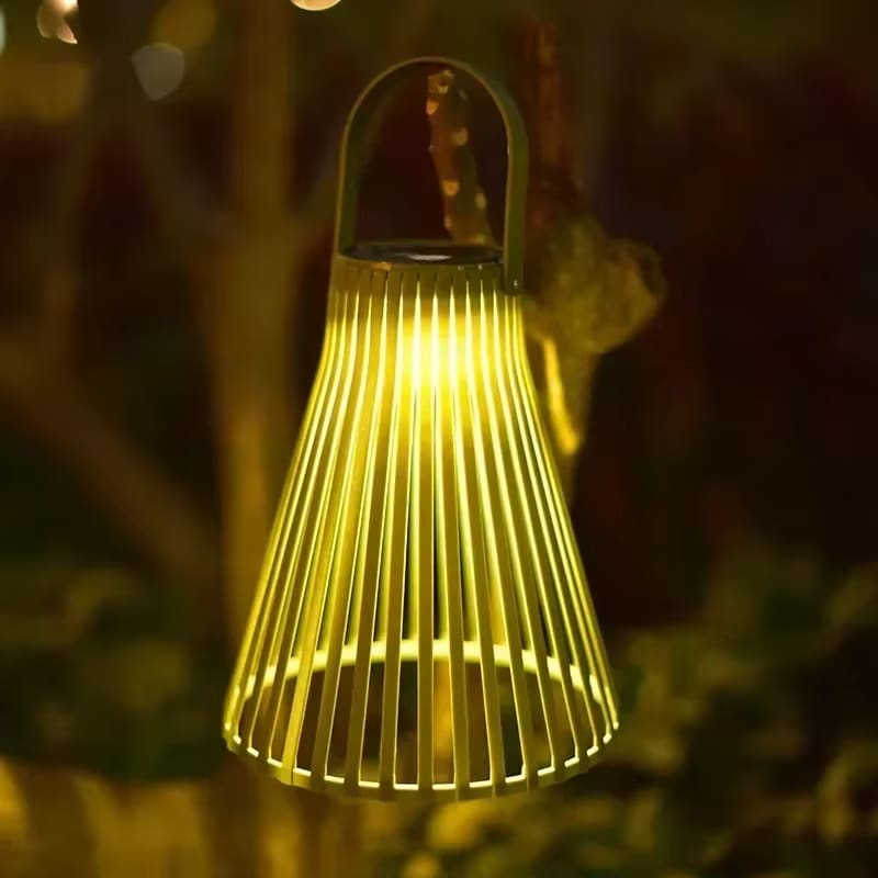 Colorful rattan-look aluminum solar lantern – green variant, shown lit outdoors