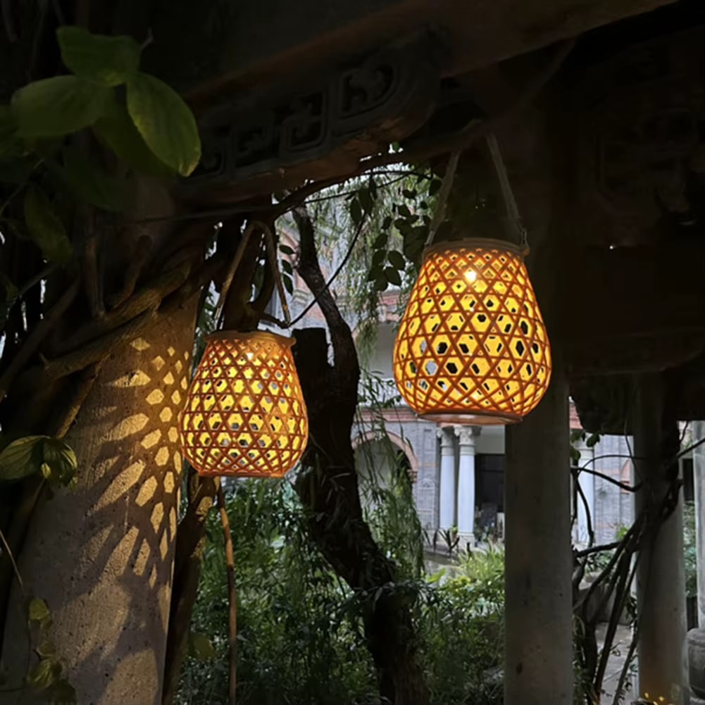 Vintage rattan-look solar lantern in beige – shown lit outdoors