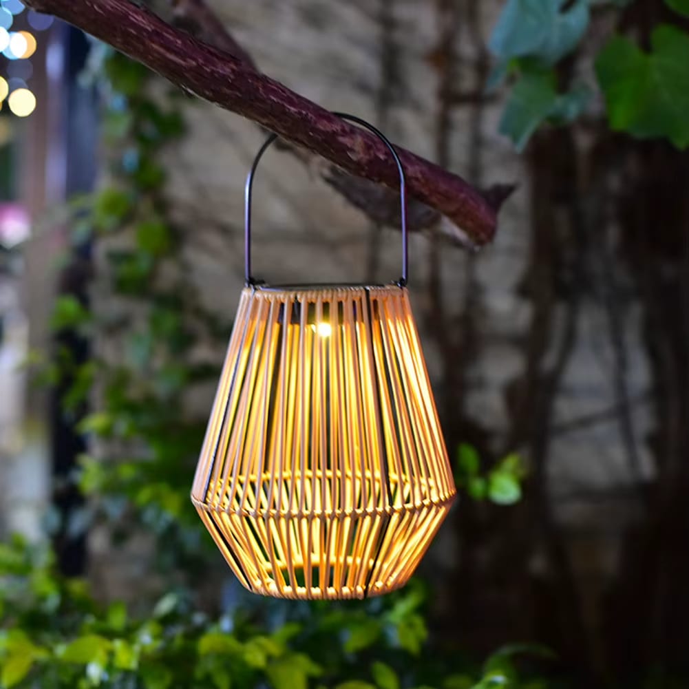 Waterproof solar rattan lantern in natural beige – shown lit outdoors