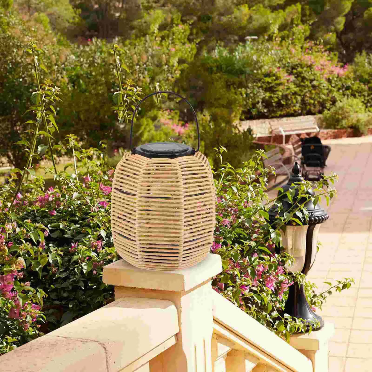Rustic solar rattan lantern with an iron frame – shown outdoors (2)