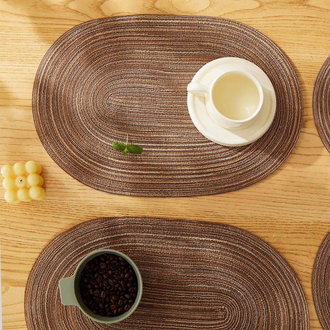 Set of four chic oval straw-look placemats – shown in a room setting