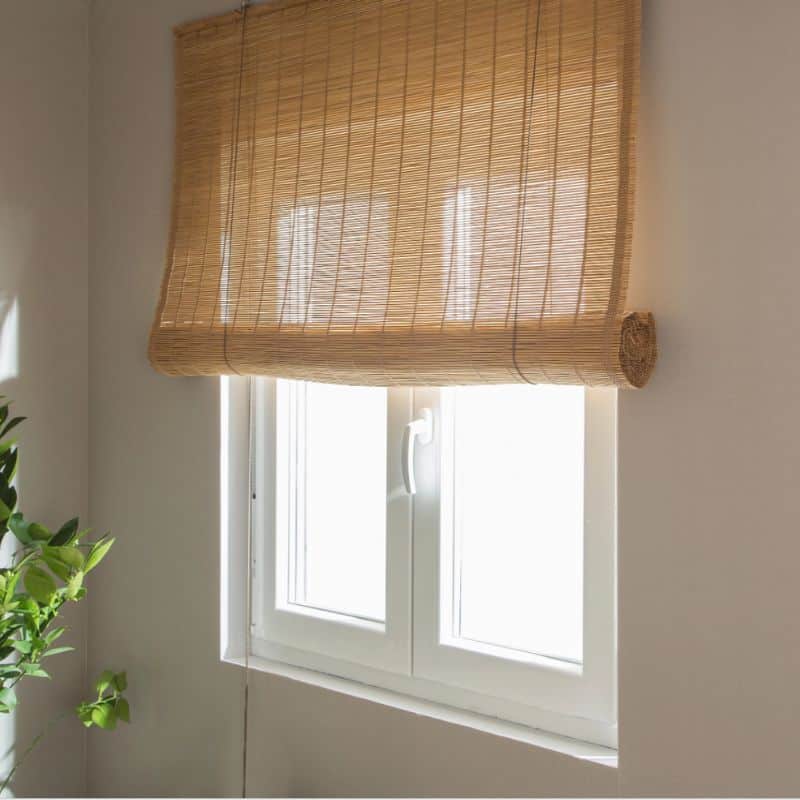 Set of two hand-woven bamboo roll-up blinds – shown in a room setting (2)
