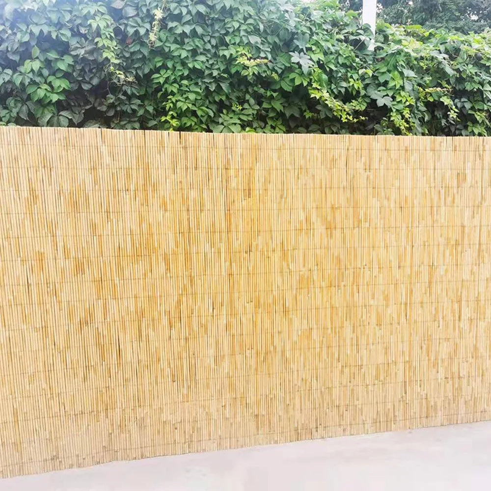Woven golden reed fence screen with a bamboo look – shown outdoors