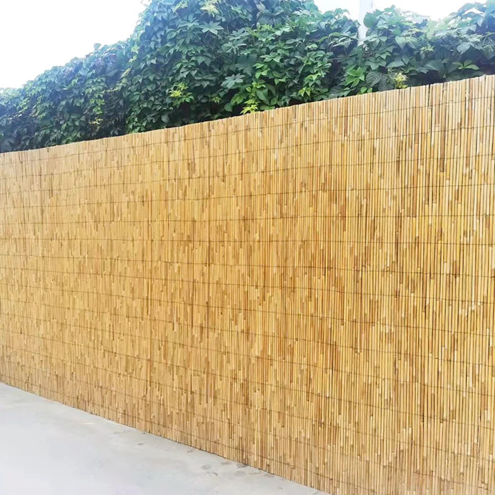 Woven golden reed fence screen with a bamboo look – shown outdoors (2)