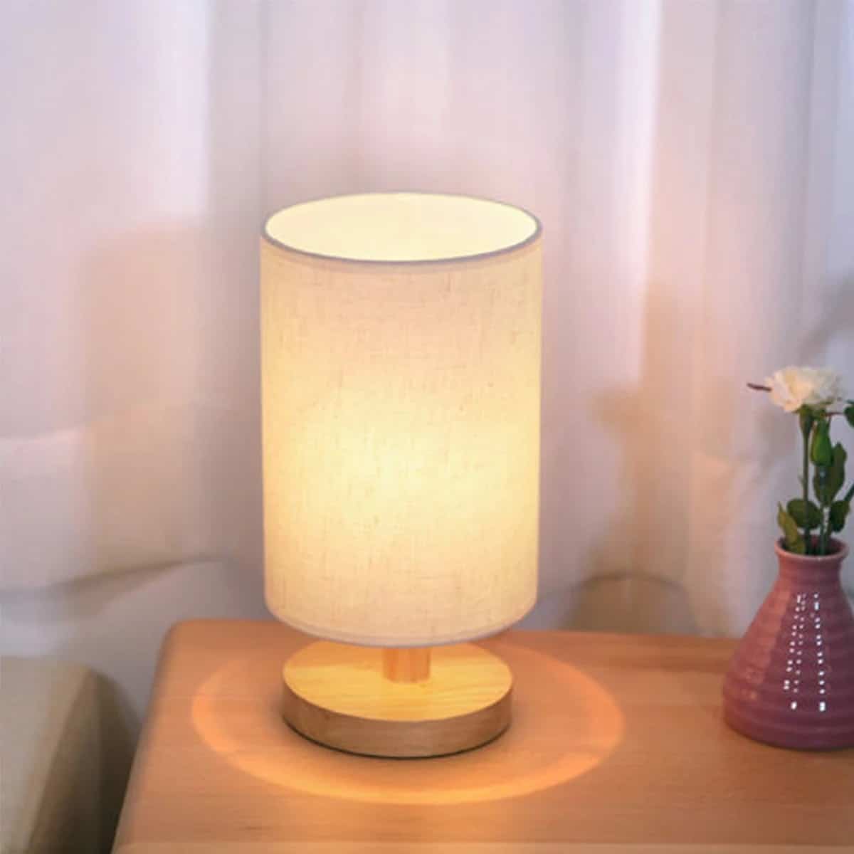 Woven wood decorative light fixture – shown lit in a room setting