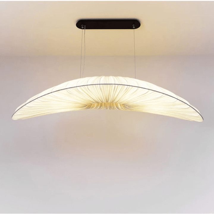 Hand-knit straw-look pendant light with golden fibers – shown lit